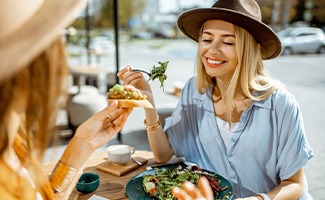Two friends eating at outdoor café