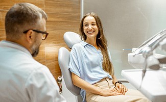 Female patient smiling at dentist at dental appointment