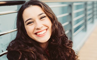 Closeup of teen girl smiling outside