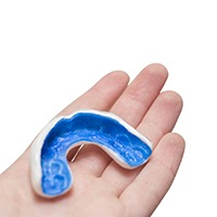hand holding a sports mouthguard